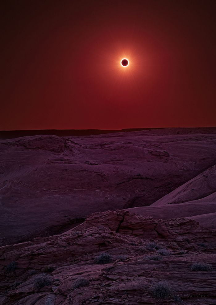 Somebody took this picture of the eclipse over a canyon and 