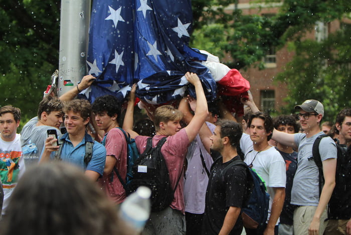 Fraternity Brothers protecting the American Flag from Angry 