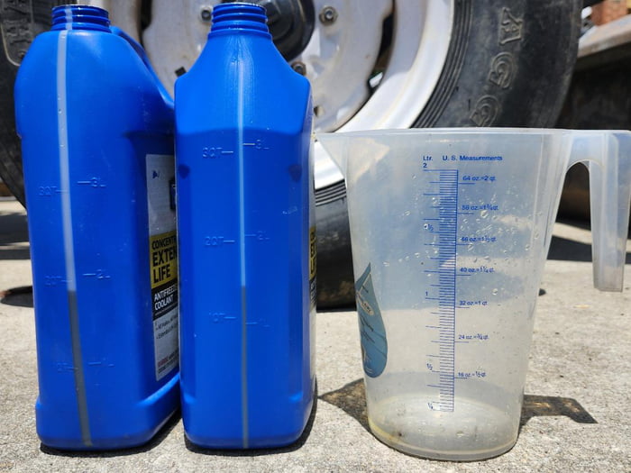 Both 1-gallon blue bottles have a measured 2 quarts in them.