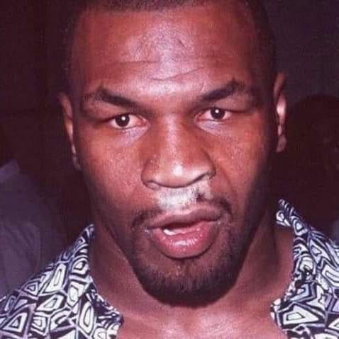 Mike Tyson enjoying powdered donuts at a house party in 1988 Image