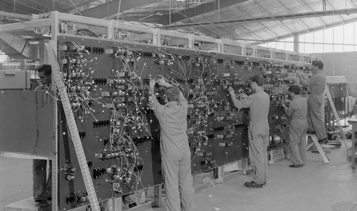 Technicians at work on a massive mainframe computer