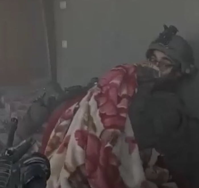 IOF soldier hides behind a blanket while under attack from H