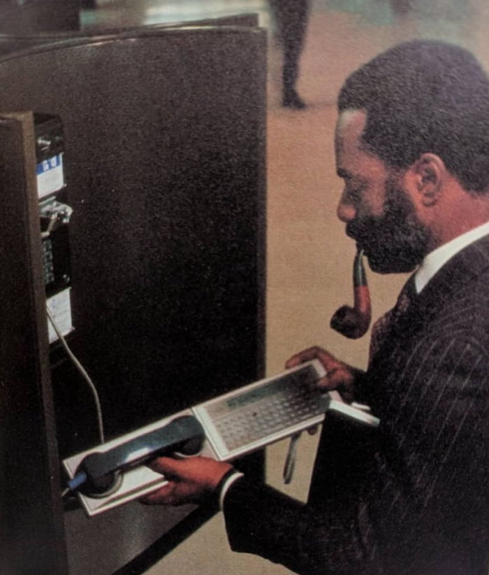 Traveling CEO checks his email, early 1980s. Image