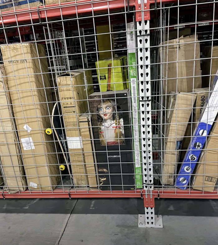 This toy doll somewhere in the middle of Amazon warehouse Image