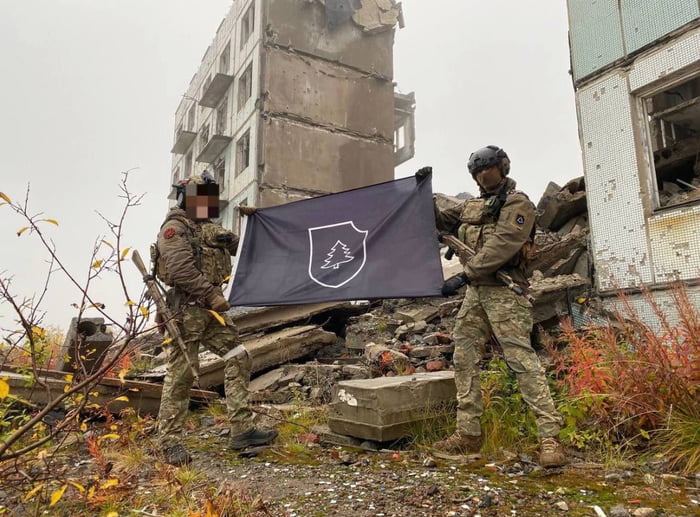 Based RuSSofascists with a Waffen-SS style flag in Marinka,  Image