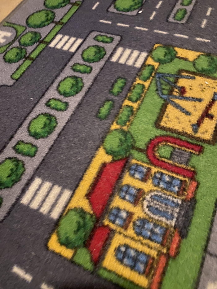 This city carpet has a bush on the street