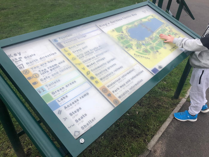A map with braille for blind people, covered in glass.